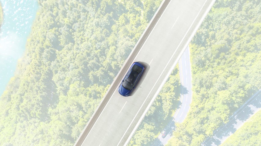 Car driving over bridge